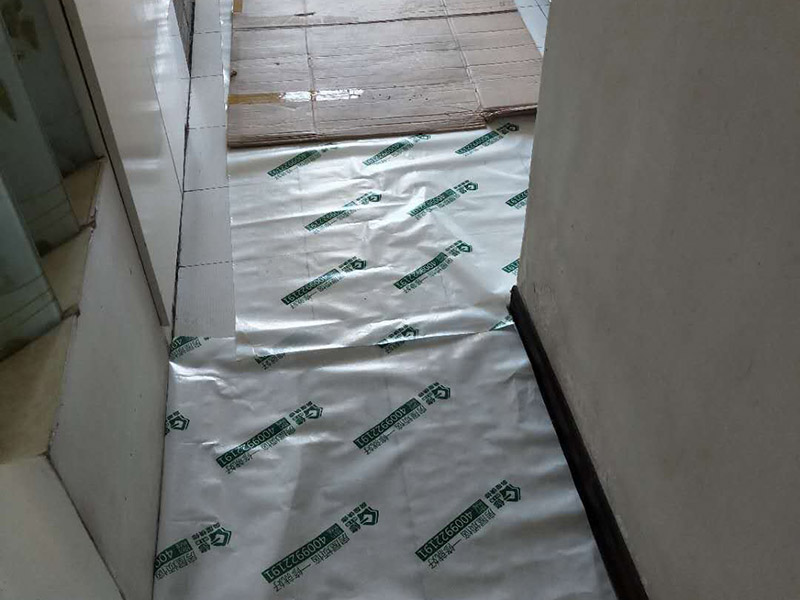 裝修地面保護：一、裝修地面保護膜鋪貼，一定是在地面（瓷磚、地板、地磚）貼好了才開始動手用裝修地面保護膜，要不然裝修地面保護膜是保護好你的地面了，但是地面（瓷磚、地板、地磚）松動了那就麻煩了，所以確認地面可以施工了這個步驟很重要！ 二、清理好地面（瓷磚、地板、地磚）表面的垃圾沙粒以及灰塵，這樣防止裝修地面保護膜在上面起到真正的保護做用（建議可以用拖把把地面清理干凈） 三、從客廳開始鋪設（建議先從面積大的地方來貼）然后逐漸到其他的地方，因為客廳是經(jīng)常走動的所以先貼好這樣不至于弄臟地面，這樣的裝修地面保護膜的保護效果更佳 四、鋪設裝修地面保護膜如果不是用專業(yè)的不基膠帶（用的是透明膠）那么就要很注意不要貼到地面上了，這樣會導致清理不干凈,那就會增加人工成本甚至刮花地面在清理的時候特別注意（木地板需要特別注意）；對于用于窗戶上的裝修保護膜，那對于窗戶的保護一定要用專業(yè)的膠帶來貼，這樣減少導致清理玻璃上的膠質了