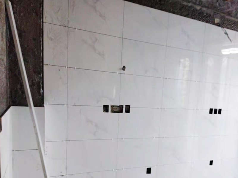 墻面貼磚施工：貼磚前對(duì)墻壁將進(jìn)行檢查，看墻壁是否有裂縫，做好修補(bǔ)，然后最好用水潤(rùn)濕墻壁，這在墻壁的瓷磚和墻壁之間是有益的更好的粘接。鋪貼墻磚時(shí)，必須先對(duì)墻磚和墻磚進(jìn)行測(cè)量和整理，這樣即規(guī)劃了位置，也保證墻磚鋪貼的美觀度。